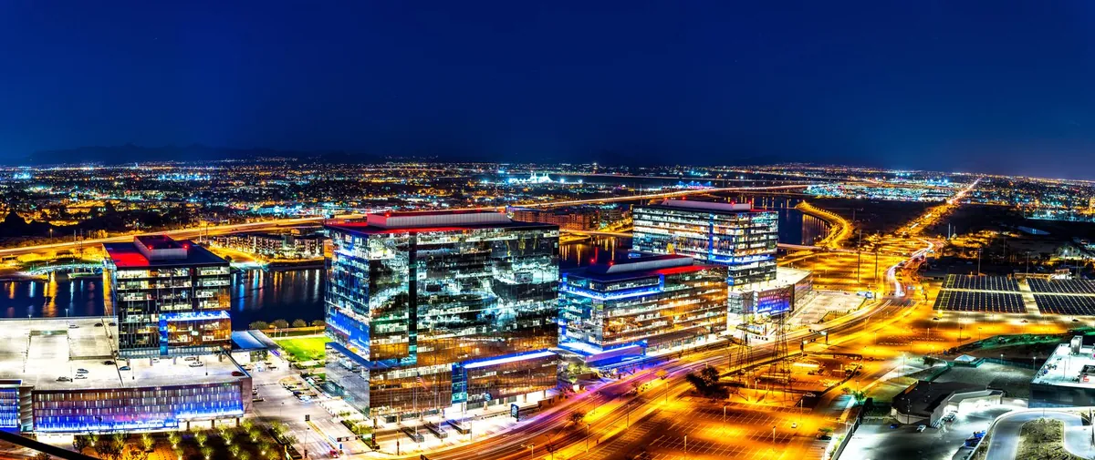 Tempe Town Lake and Phoenix East Valley office towers lit up at night