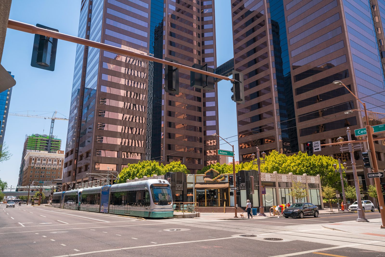 Light rail train on a downtown Phoenix street beside high-rise towers
