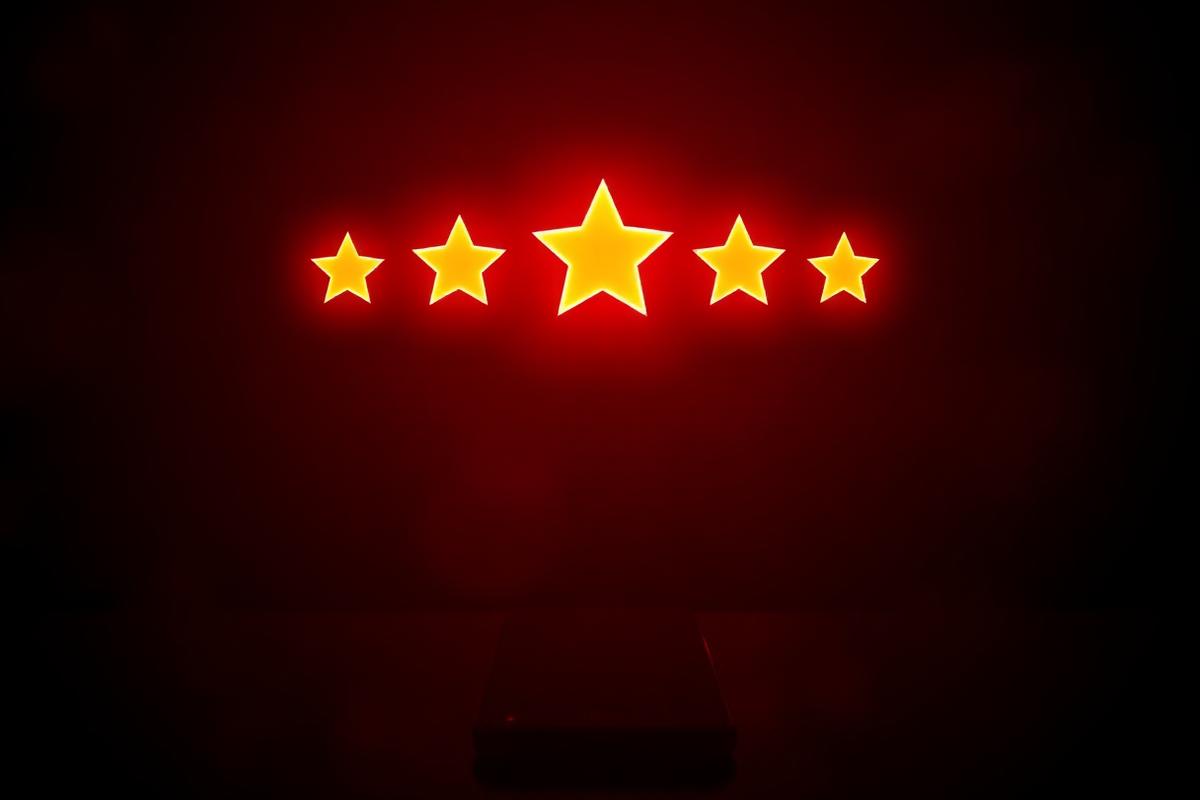 Glowing five star rating above a phone representing reviews