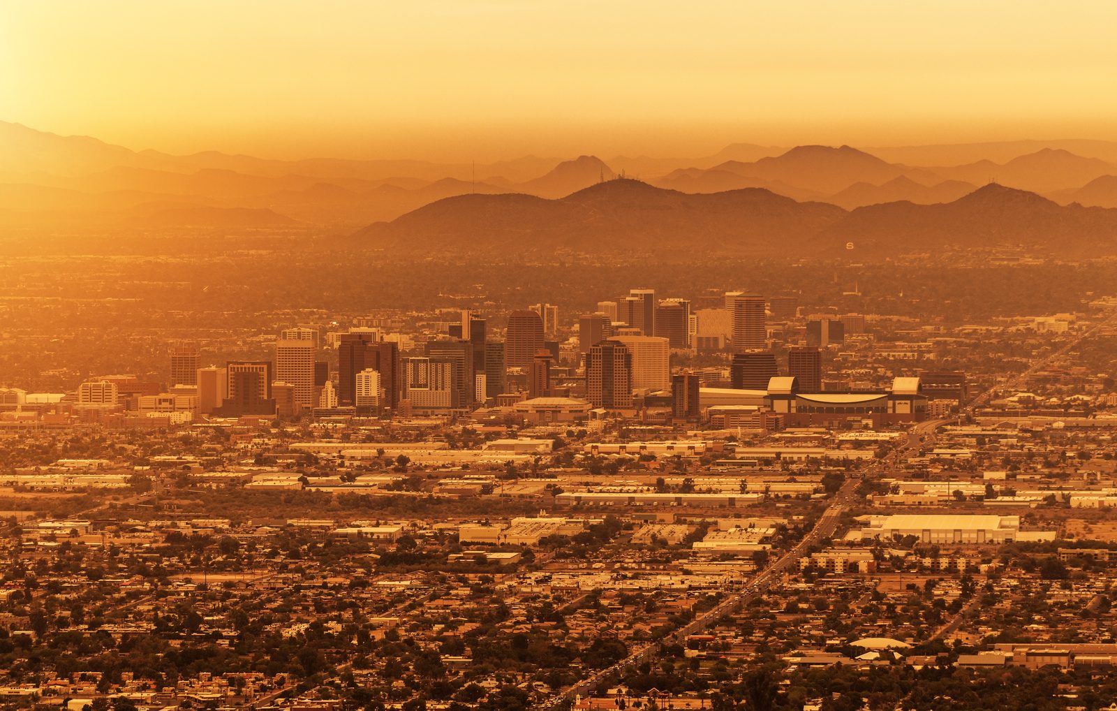 Aerial view of the Phoenix metro area under a golden desert sunset